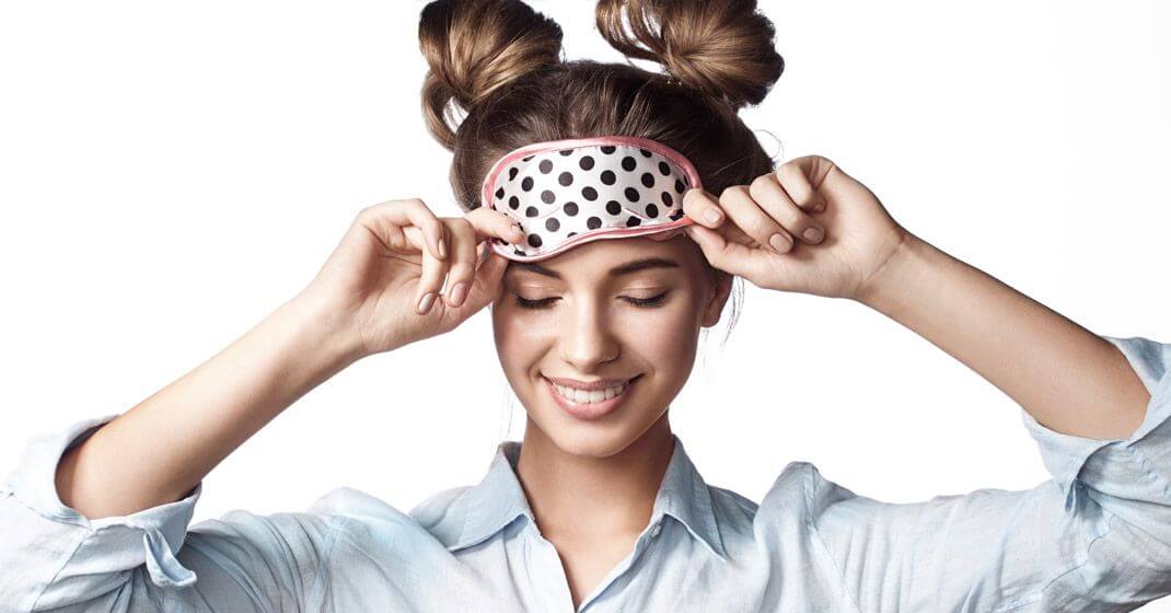 girl with sleeping mask over eyes