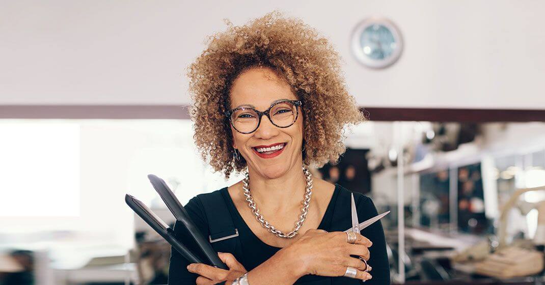 hairdresser holding scissors and straightner