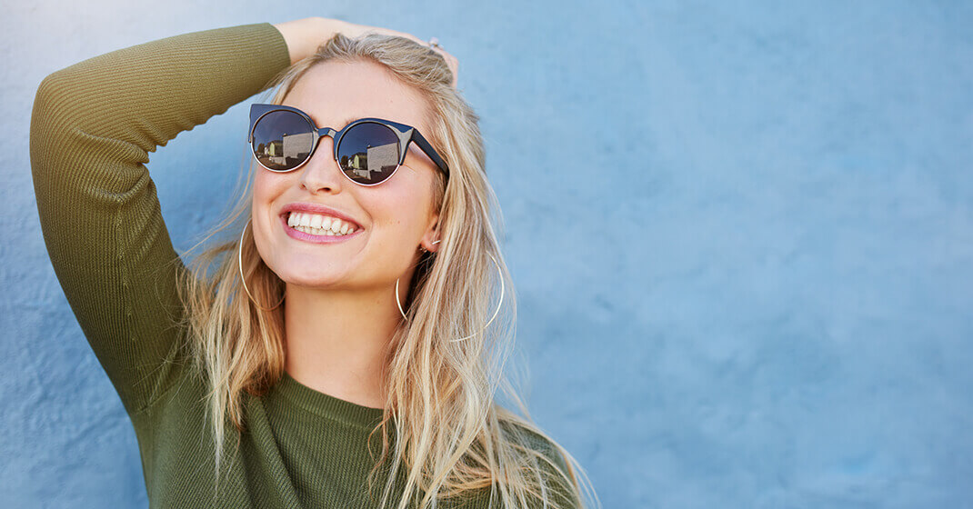 woman smiling against blue background