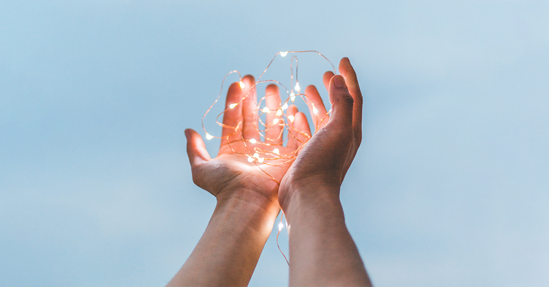 hands holding a string of lights