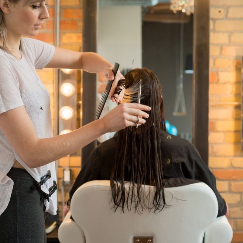 salon owner combing client's hair