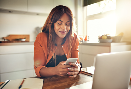 Women looking at phone in her hand smiling