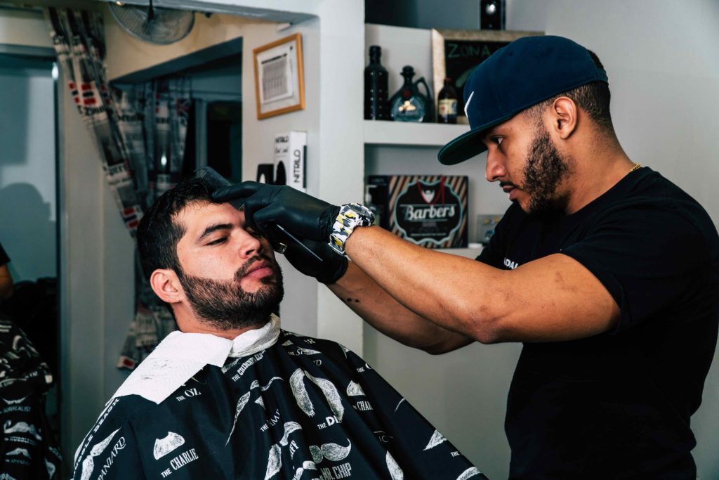 New barber hire trimming client's hair