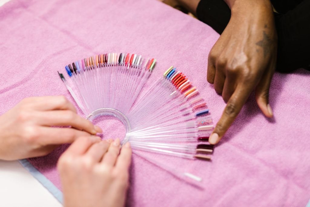 Woman pointing to nails in salon