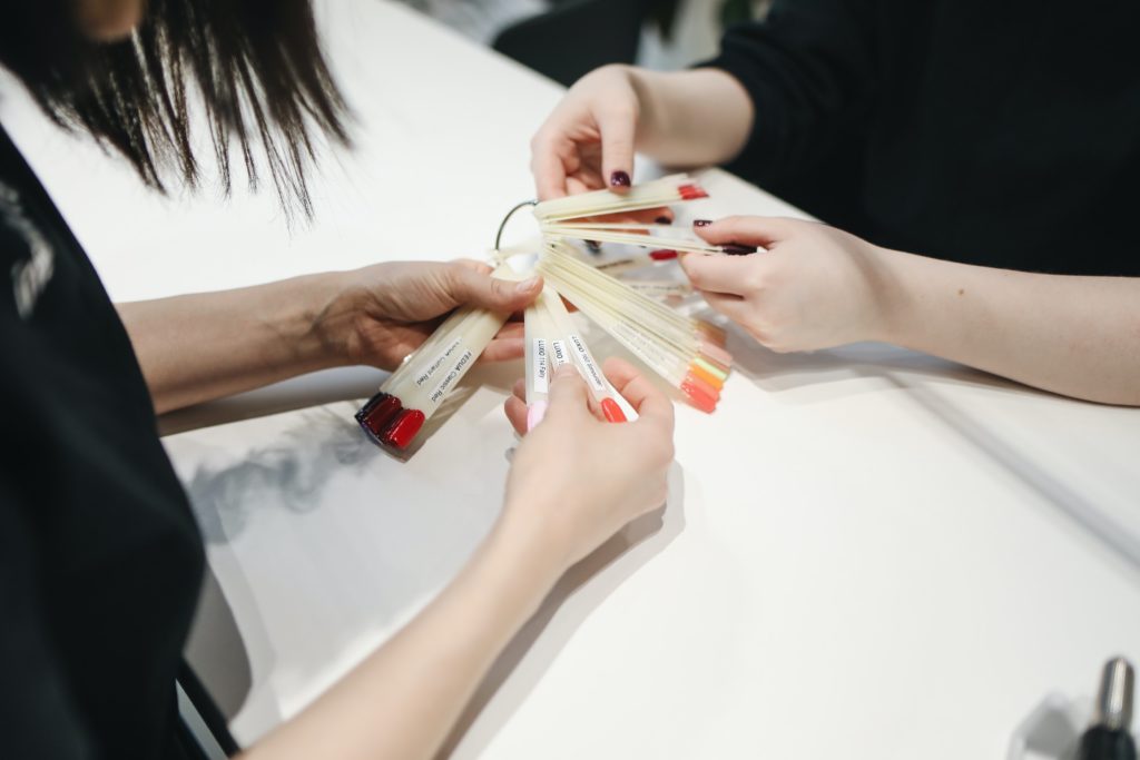 customer choosing nail colour at beauty salon