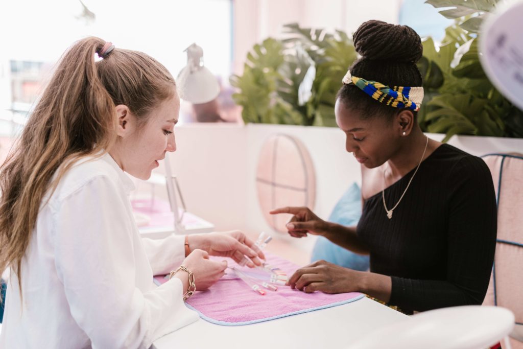 customer getting nails done in beauty salon